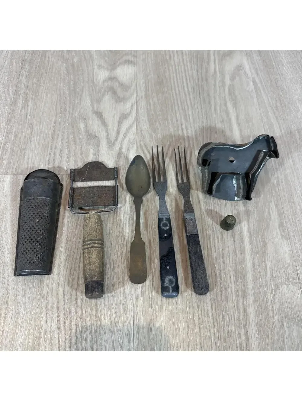 (7) Antique items: 2 graters, 2 forks, 1 spoon,‎ cookie cutter, thimble.